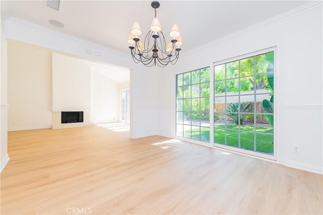 29355 Shell Cv, Laguna Niguel, CA 92677 - unfurnished living room with light wood-type flooring, a chandelier, ornamental molding, a fireplace with raised hearth, and baseboards
