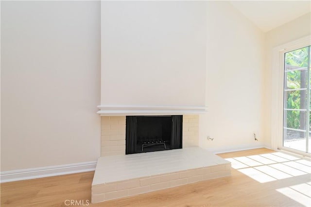 29355 Shell Cv, Laguna Niguel, CA 92677 - unfurnished living room featuring wood finished floors, baseboards, a fireplace, and lofted ceiling