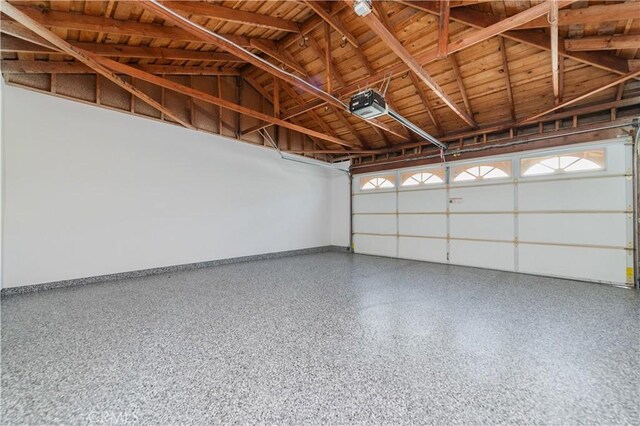 29355 Shell Cv, Laguna Niguel, CA 92677 - garage featuring a garage door opener, wooden ceiling, and baseboards
