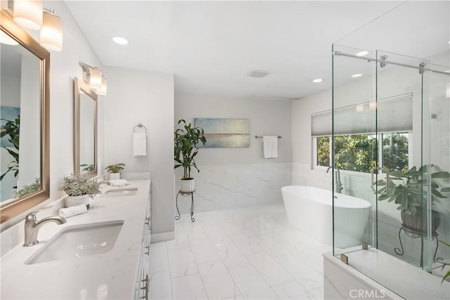 33028 Christina Dr, Dana Point, CA 92629 - bathroom with marble finish floors, a soaking tub, recessed lighting, double vanity, and an enclosed shower