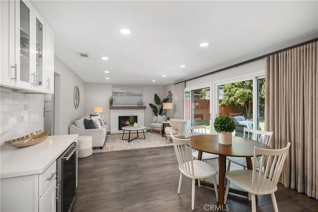 33028 Christina Dr, Dana Point, CA 92629 - dining space featuring wine cooler, recessed lighting, dark wood-type flooring, and a fireplace