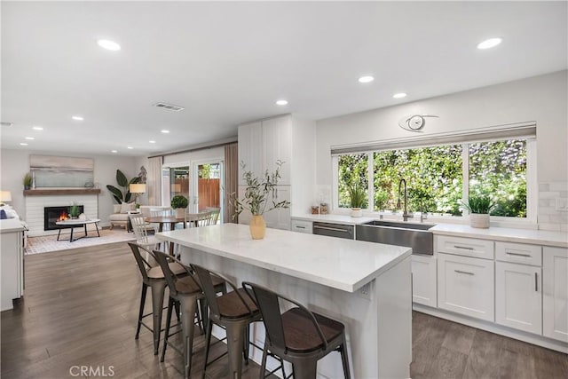 33028 Christina Dr, Dana Point, CA 92629 - kitchen featuring white cabinets, plenty of natural light, a breakfast bar area, recessed lighting, and a center island