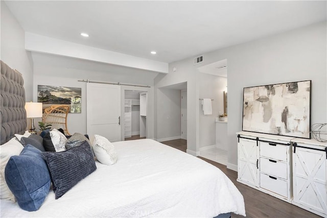 33028 Christina Dr, Dana Point, CA 92629 - bedroom featuring a barn door, dark wood-style floors, recessed lighting, ensuite bathroom, and a walk in closet