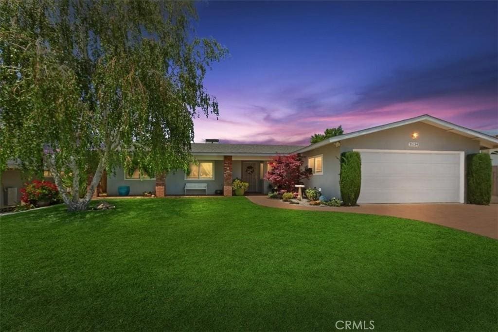 35134 Forest Ln, Yucaipa, CA 92399 - ranch-style house featuring a garage, a yard, driveway, and stucco siding