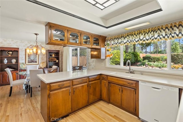 6680 Brook Way, Paradise, CA 95969 - kitchen featuring white dishwasher, a sink, a raised ceiling, a peninsula, and brown cabinets