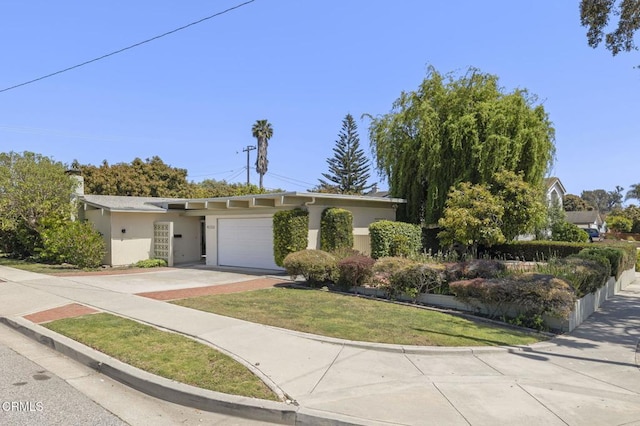 4232 De Paul St, Ventura, CA 93003 - view of front facade with concrete driveway, a garage, stucco siding, and a front lawn