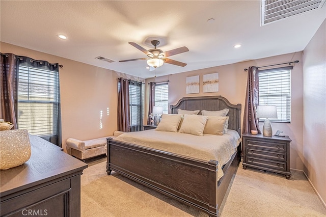 bedroom with light carpet, multiple windows, recessed lighting, and ceiling fan