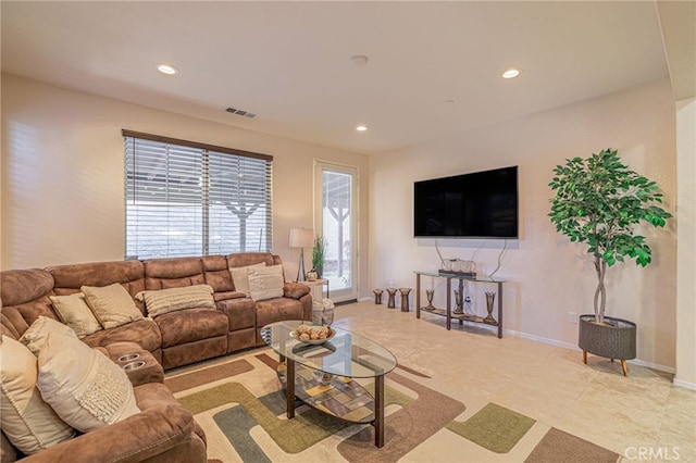 living room featuring recessed lighting and baseboards