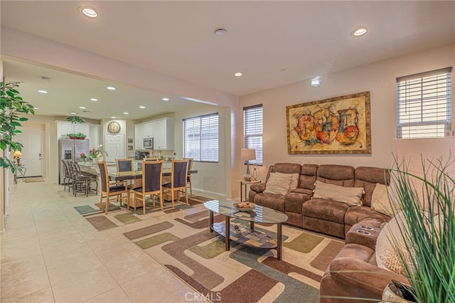 living area with recessed lighting, light tile patterned floors, and baseboards