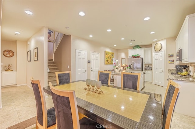 dining area featuring light tile patterned floors, recessed lighting, and stairway