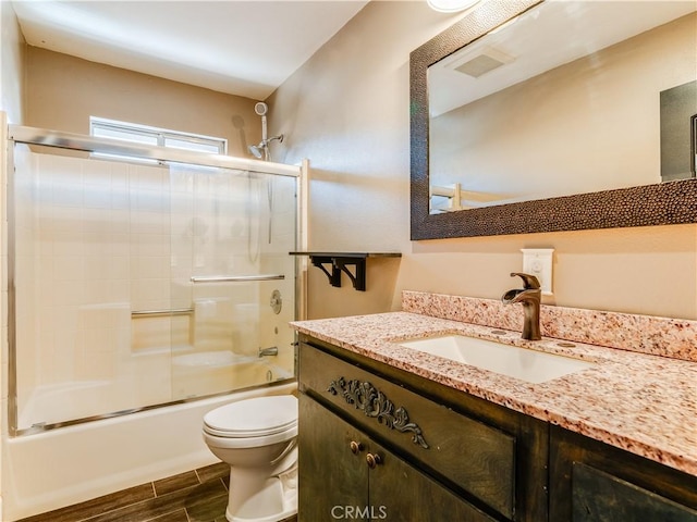 2690 Chaparral Ln, Paso Robles, CA 93446 - bathroom featuring toilet, wood finish floors, shower / bath combination with glass door, and vanity