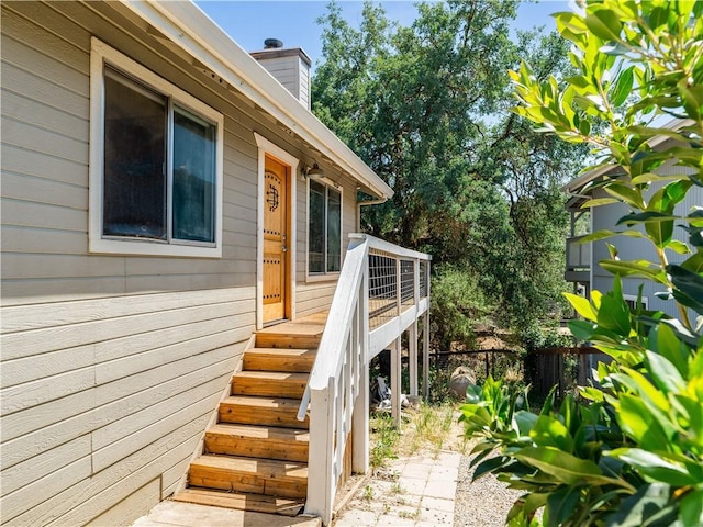 2690 Chaparral Ln, Paso Robles, CA 93446 - property entrance with fence, a wooden deck, and a chimney