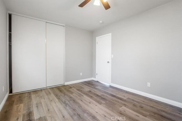 14351 Cronese Rd, Apple Valley, CA 92307 - unfurnished bedroom with a closet, wood finished floors, baseboards, and a ceiling fan