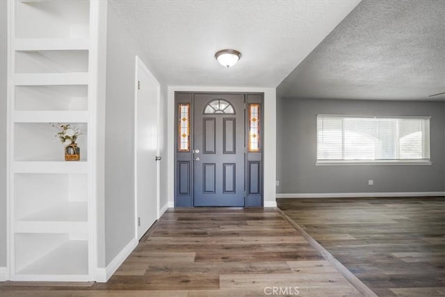 14351 Cronese Rd, Apple Valley, CA 92307 - foyer entrance featuring a textured ceiling, baseboards, and wood finished floors