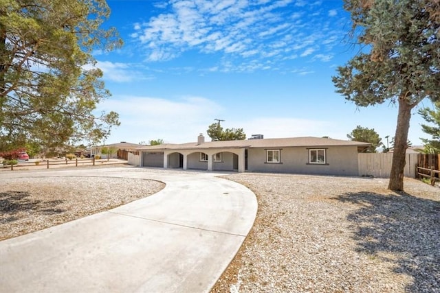 14351 Cronese Rd, Apple Valley, CA 92307 - ranch-style house with fence, a garage, curved driveway, and stucco siding
