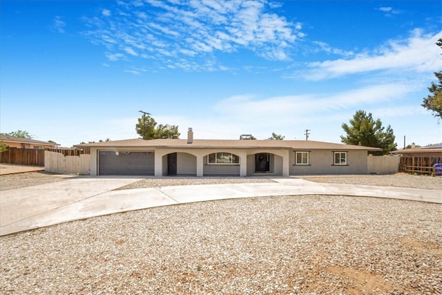 14351 Cronese Rd, Apple Valley, CA 92307 - ranch-style home with concrete driveway, an attached garage, fence, stucco siding, and covered porch
