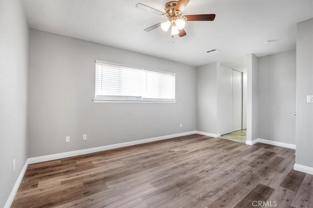 14351 Cronese Rd, Apple Valley, CA 92307 - unfurnished room featuring a ceiling fan, wood finished floors, and baseboards
