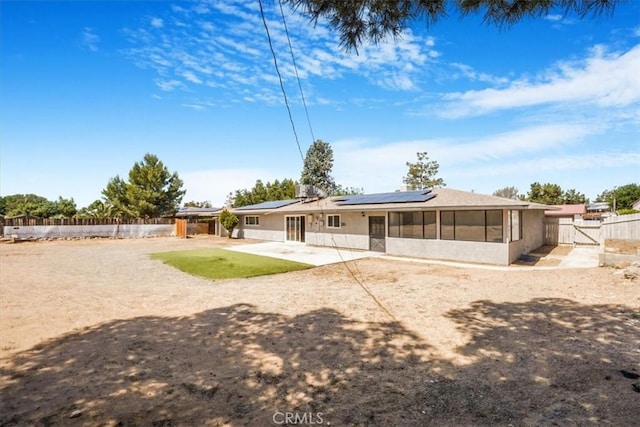14351 Cronese Rd, Apple Valley, CA 92307 - rear view of property with a sunroom, a patio area, solar panels, a fenced backyard, and a gate
