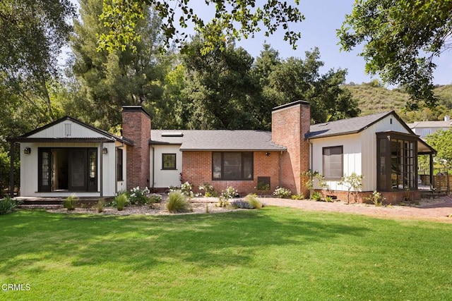 1555 Scenic Dr, Pasadena, CA 91103 - view of front of home with a chimney, a front yard, and brick siding