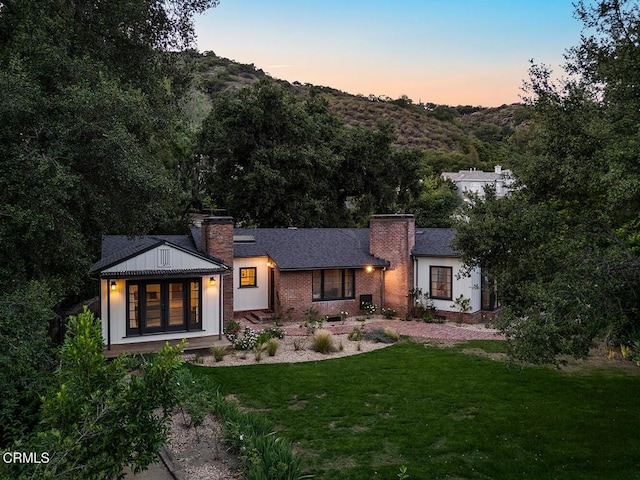 1555 Scenic Dr, Pasadena, CA 91103 - back of house with a chimney, a yard, and brick siding