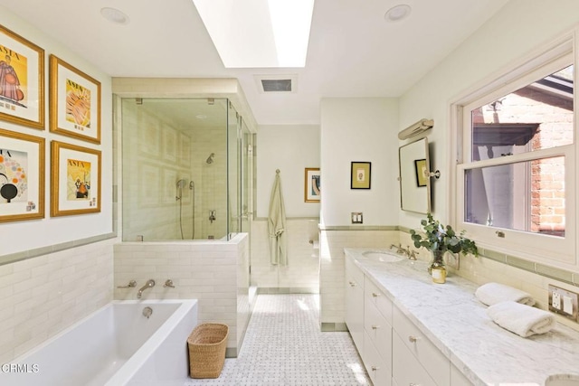 1555 Scenic Dr, Pasadena, CA 91103 - bathroom featuring tile walls, a shower stall, double vanity, a bath, and a wainscoted wall
