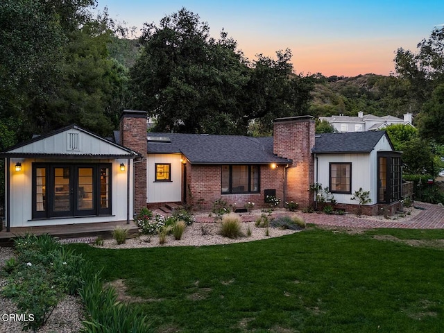 1555 Scenic Dr, Pasadena, CA 91103 - rear view of house featuring a chimney, a yard, and board and batten siding