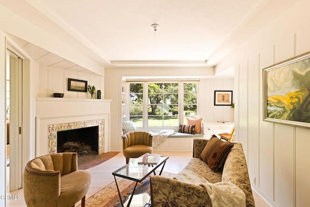1555 Scenic Dr, Pasadena, CA 91103 - living room featuring a tile fireplace, light wood finished floors, a decorative wall, and a tray ceiling