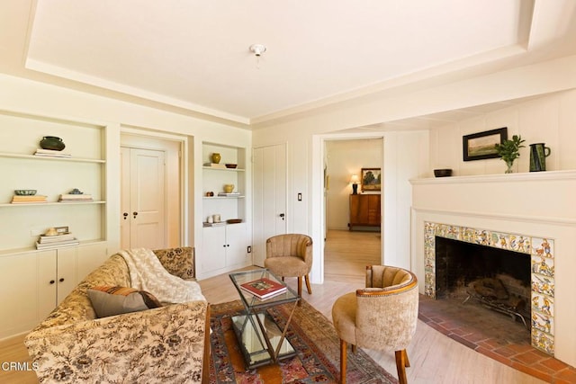1555 Scenic Dr, Pasadena, CA 91103 - living room with built in features, wood finished floors, and a tile fireplace