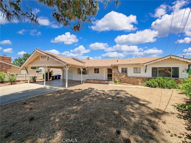11674 Oak Ln, Yucaipa, CA 92399 - ranch-style house featuring driveway, a garage, a carport, a chimney, and brick siding