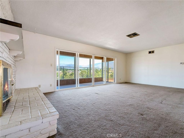 11674 Oak Ln, Yucaipa, CA 92399 - unfurnished living room featuring carpet flooring, a fireplace, and a textured ceiling