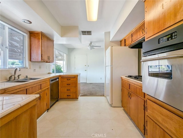 11674 Oak Ln, Yucaipa, CA 92399 - kitchen with dishwasher, tile counters, stainless steel oven, light floors, and a ceiling fan