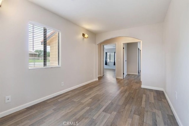 43324 45th St W, Lancaster, CA 93536 - empty room with arched walkways, wood finished floors, and baseboards