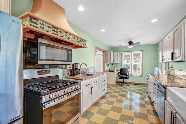 521 W Whiting Ave, Fullerton, CA 92832 - kitchen with appliances with stainless steel finishes, a ceiling fan, light stone countertops, white cabinets, and recessed lighting