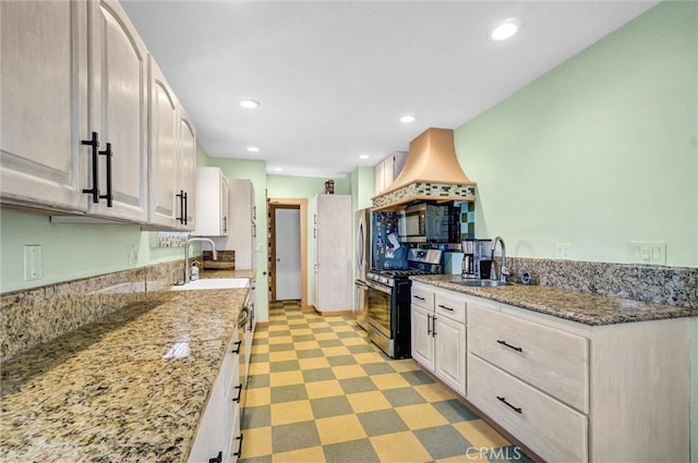 521 W Whiting Ave, Fullerton, CA 92832 - kitchen featuring gas range, light stone countertops, recessed lighting, light floors, and white cabinetry