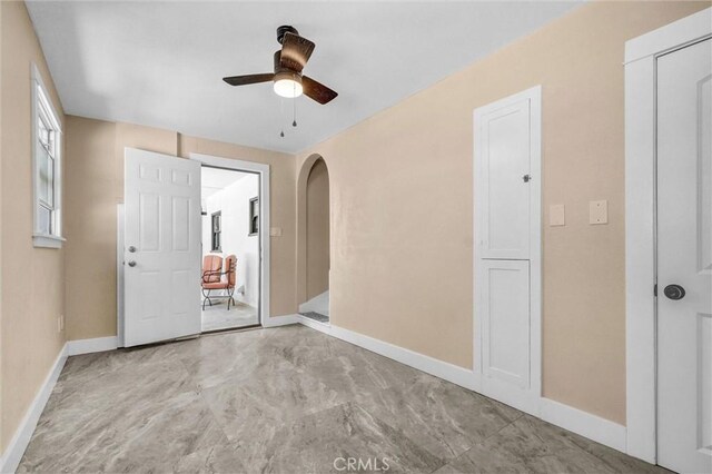 521 W Whiting Ave, Fullerton, CA 92832 - unfurnished bedroom with arched walkways and a ceiling fan
