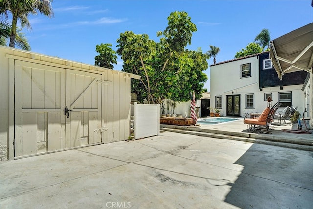 521 W Whiting Ave, Fullerton, CA 92832 - view of patio with a storage shed and an outdoor pool