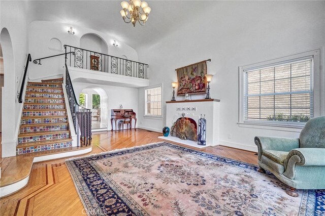 521 W Whiting Ave, Fullerton, CA 92832 - living area featuring arched walkways, stairs, a chandelier, and high vaulted ceiling