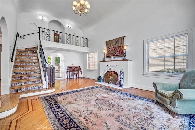 521 W Whiting Ave, Fullerton, CA 92832 - living area with arched walkways, stairs, a chandelier, and high vaulted ceiling