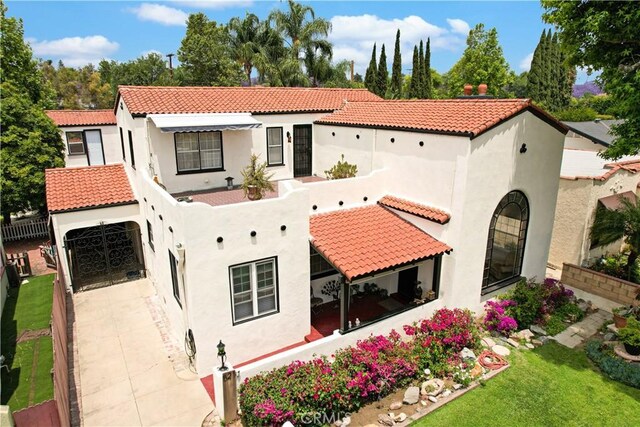 521 W Whiting Ave, Fullerton, CA 92832 - mediterranean / spanish house featuring a tile roof, driveway, and stucco siding