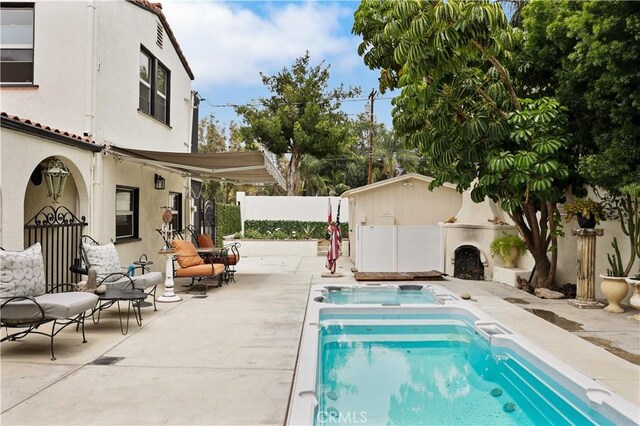 521 W Whiting Ave, Fullerton, CA 92832 - view of pool featuring a fenced backyard, a jacuzzi, and a patio area