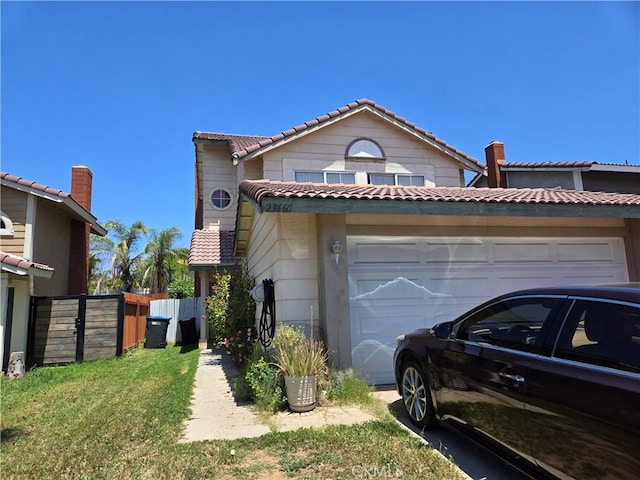 23660 Parkland Ave, Moreno Valley, CA 92557 - view of front facade with a garage, a tile roof, fence, and driveway