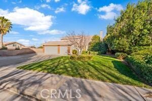 view of front facade with concrete driveway and a garage