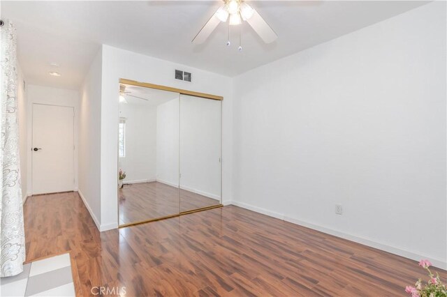 28083 Langside Ave, Canyon Country, CA 91351 - unfurnished bedroom with wood finished floors, baseboards, a closet, and ceiling fan