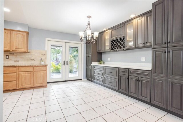 28083 Langside Ave, Canyon Country, CA 91351 - kitchen featuring light countertops, a chandelier, tasteful backsplash, french doors, and hanging light fixtures