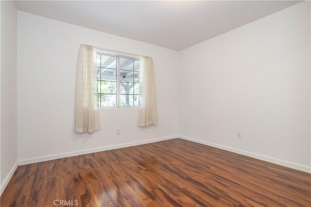 28083 Langside Ave, Canyon Country, CA 91351 - empty room featuring baseboards and dark wood-style flooring