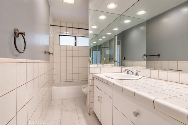 28083 Langside Ave, Canyon Country, CA 91351 - full bath featuring recessed lighting, toilet, vanity, tile walls, and bathtub / shower combination