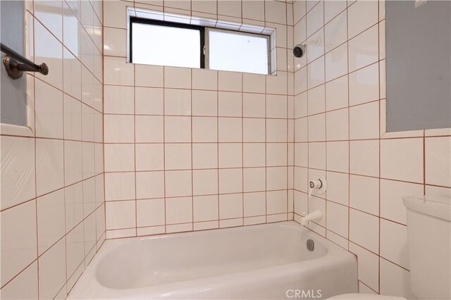 28083 Langside Ave, Canyon Country, CA 91351 - bathroom with toilet, washtub / shower combination, and tile walls