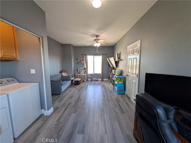 22132 Esaws Rd, Apple Valley, CA 92307 - living room featuring washer and dryer, ceiling fan, wood finished floors, and baseboards