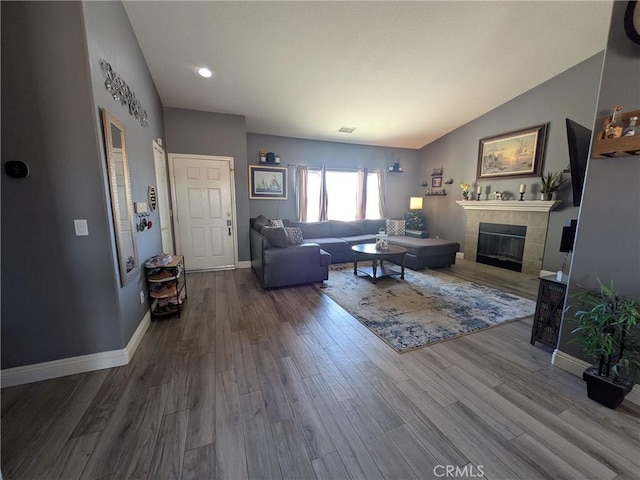 22132 Esaws Rd, Apple Valley, CA 92307 - living room featuring a tiled fireplace, wood finished floors, baseboards, and lofted ceiling
