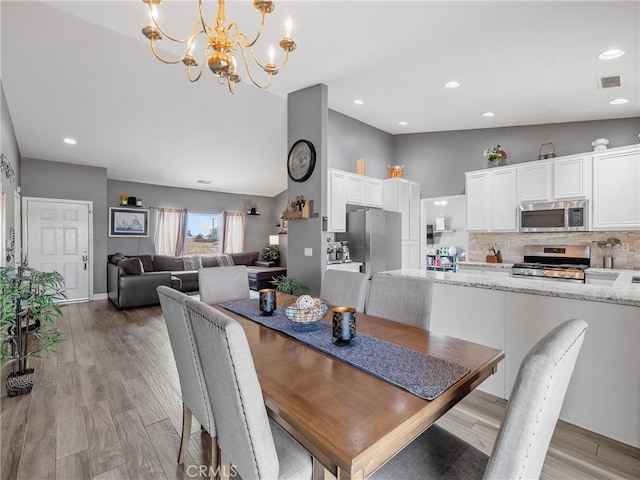 22132 Esaws Rd, Apple Valley, CA 92307 - dining room with a chandelier, light wood finished floors, high vaulted ceiling, and recessed lighting